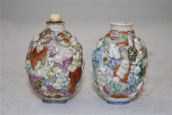 Two Chinese moulded famille rose eighteen luohan snuff bottles, Qianlong marks, but 1821-50, height 7.2cm, one with rim chips